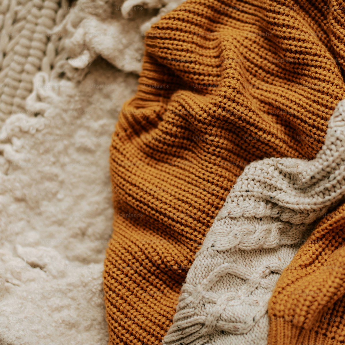 Chunky cable knit throw blanket in neutral tones