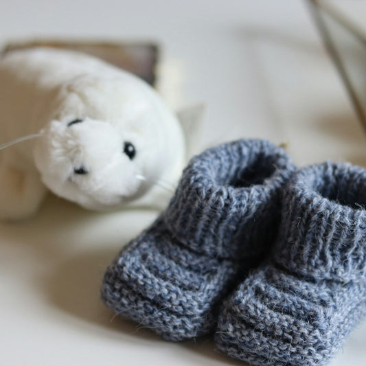 Knitted baby booties and matching hat