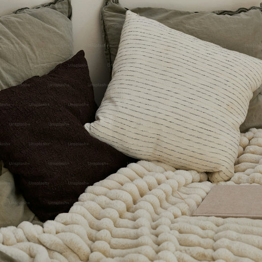 Textured knitted cushions on sofa